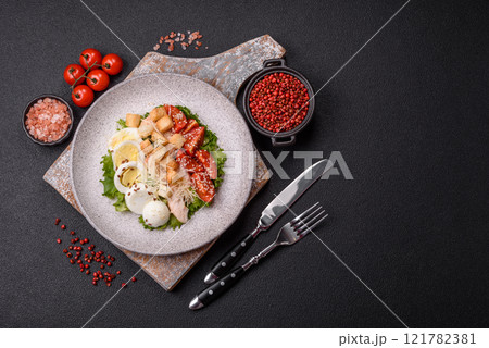 Delicious fresh salad with lettuce, croutons, chicken fillet, tomatoes and egg Delicious fresh salad with lettuce, croutons, chicken fillet, tomatoes and egg 121782381