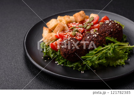 Hearty delicious fried falafel made from chickpeas, cumin, hummus with salt and spices Hearty delicious fried falafel made from chickpeas, cumin, hummus with salt and spices 121782385