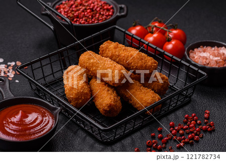 Delicious crispy cheese sticks with mozzarella, salt and spices Delicious crispy cheese sticks with mozzarella, salt and spices 121782734