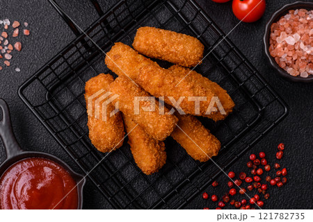 Delicious crispy cheese sticks with mozzarella, salt and spices Delicious crispy cheese sticks with mozzarella, salt and spices 121782735