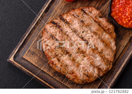Juicy grilled beef or pork steak with salt, spices and herbs 121782882
