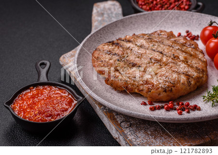 Juicy grilled beef or pork steak with salt, spices and herbs 121782893