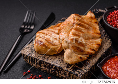 Delicious fresh grilled chicken fillet with spices and herbs Delicious fresh grilled chicken fillet with spices and herbs 121782913