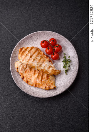 Delicious fresh grilled chicken fillet with spices and herbs Delicious fresh grilled chicken fillet with spices and herbs 121782924