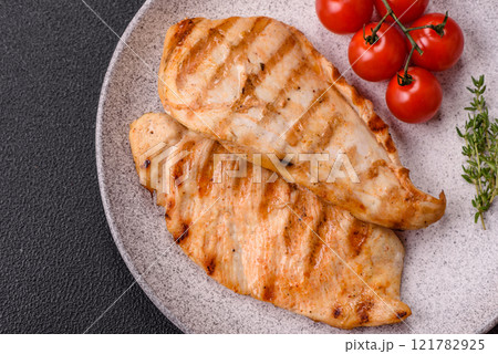Delicious fresh grilled chicken fillet with spices and herbs Delicious fresh grilled chicken fillet with spices and herbs 121782925