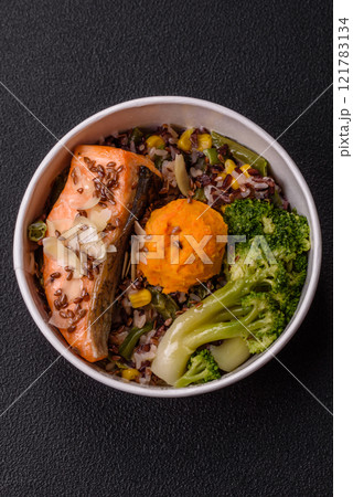 Grilled salmon with salt and spices, broccoli, tomatoes, rice 121783134