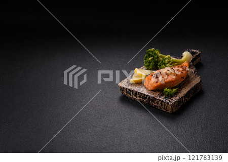 Grilled salmon with salt and spices, broccoli, tomatoes, rice 121783139