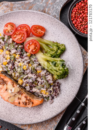 Grilled salmon with salt and spices, broccoli, tomatoes, rice 121783170
