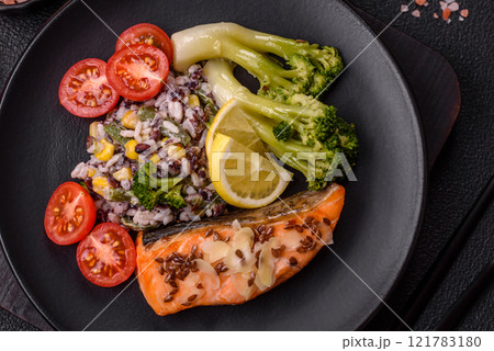 Grilled salmon with salt and spices, broccoli, tomatoes, rice 121783180