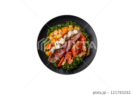 Appetizing salad with prosciutto, pumpkin, cheese and tomatoes Appetizing salad with prosciutto, pumpkin, cheese and tomatoes 121783282