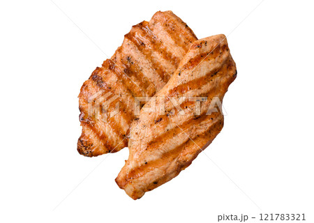 Juicy chicken fillet baked on the grill with salt, spices and herbs Juicy chicken fillet baked on the grill with salt, spices and herbs 121783321