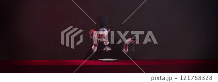 Banner. Vampire dressed in black cloak and top hat holds heart in one hand, inspecting it closely, while holding glass of red wine in other hand. Banner. Vampire dressed in black cloak and top hat holds heart in one hand, inspecting it closely, while holding glass of red wine in other hand. 121788328