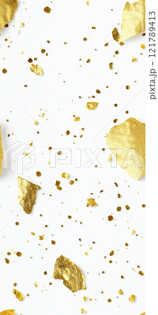 Gold and black paint splattering on white canvas background. Sprinkled gold 121789413