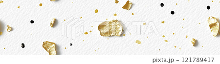 Gold and black paint splattering on white canvas background. Sprinkled gold 121789417