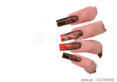 Fingers with a beautiful manicure in a hole in the paper.Nail design. Extended nails. Fingers with a beautiful manicure in a hole in the paper.Nail design. Extended nails. 121790558