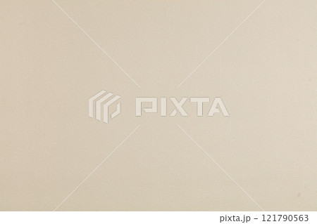 Background of beige evenly textured paper wallpaper. Beige plastered wall. Background of beige evenly textured paper wallpaper. Beige plastered wall. 121790563
