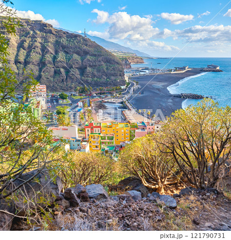 Beautiful landscape of a small colorful coastal city near the beach. Bright and vibrant town near the sea and mountain with a cloudy blue sky. Scenic view of vintage and old urban village Beautiful landscape of a small colorful coastal city near the beach. Bright and vibrant town near the sea and mountain with a cloudy blue sky. Scenic view of vintage and old urban village 121790731