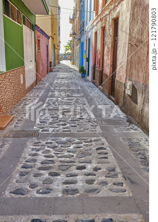 City street view of residential houses or buildings in leading alleyway in Santa Cruz, La Palma, Spain. Historical spanish and colonial architecture in tropical village and famous tourism destination City street view of residential houses or buildings in leading alleyway in Santa Cruz, La Palma, Spain. Historical spanish and colonial architecture in tropical village and famous tourism destination 121790803