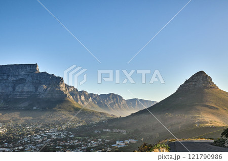 Mountain background, landscape of Table mountain and suburb with private houses against a blue sky background with copyspace. Beautiful view of vegetation surrounding city in Cape Town, South Africa 121790986