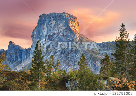 Scenic mountain landscape view with forest trees and blue sky in Norway, with copy space. Beautiful scenic view of nature with vibrant lush trees around an iconic natural landmark on a sunny day 121791003