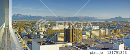 Cityscape view of urban city buildings and infrastructure with background mountains in popular overseas travel destination. Busy downtown centre and urban architecture and blue sky in Bodo, Norway 121791238