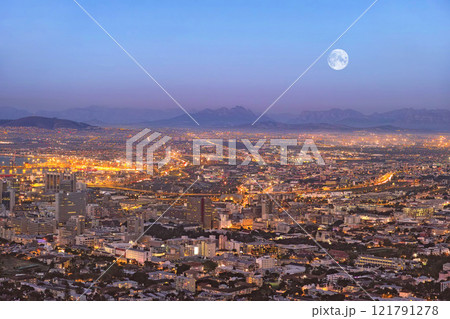 Copy space night view of city buildings with electricity lights, infrastructure and moon with mountain background in travel destination. Cape Town, South Africa downtown centre and urban architecture Copy space night view of city buildings with electricity lights, infrastructure and moon with mountain background in travel destination. Cape Town, South Africa downtown centre and urban architecture 121791278