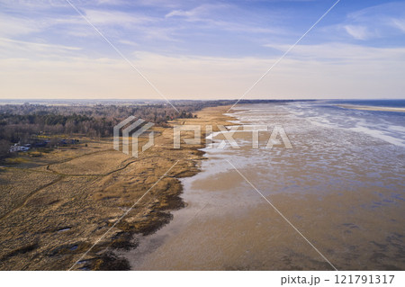Beautiful landscape of forest dry land near the beach with copy space. Aerial view of the coastline on a summer day with a cloudy blue sky background and copyspace. A peaceful view of the coast 121791317