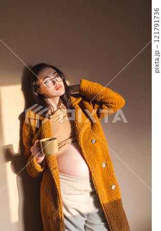 Portrait of pregnant woman with a cup of tea. Portrait of pregnant woman with a cup of tea. 121791736