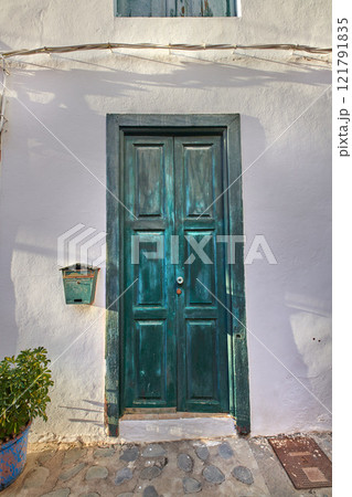 Vintage of wooden door on historical street in tropical village or city of Santa Cruz, La Palma, Spain. Texture detail of vibrant blue entrance way leading to comfortable home in tourism destination Vintage of wooden door on historical street in tropical village or city of Santa Cruz, La Palma, Spain. Texture detail of vibrant blue entrance way leading to comfortable home in tourism destination 121791835
