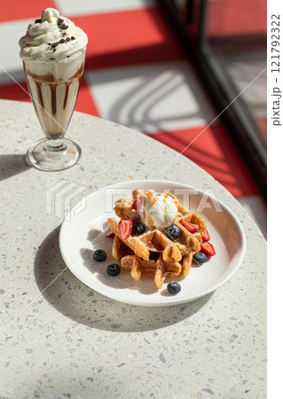 Portion of waffles with ice cream and milkshake Portion of waffles with ice cream and milkshake 121792322
