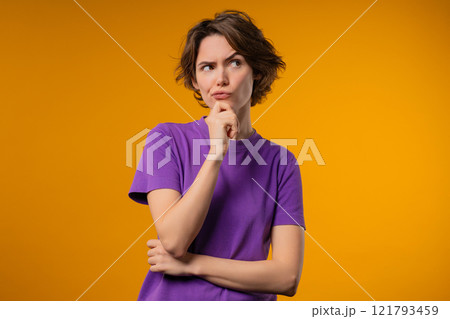 Thinking around stylish woman on yellow background. Puzzled lady looking answer Thinking around stylish woman on yellow background. Puzzled lady looking answer 121793459