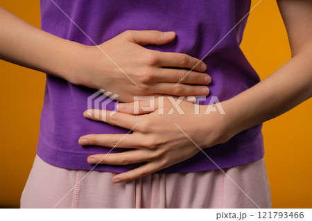 Young woman squeezing belly with hands. abdominal pain, suffering stomach ache Young woman squeezing belly with hands. abdominal pain, suffering stomach ache 121793466