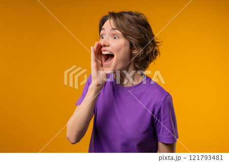 Attention, portrait of young woman shouting, holding hand near open mouth Attention, portrait of young woman shouting, holding hand near open mouth 121793481