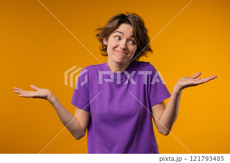 Confused pretty woman, shoulders up - can't help, makes gesture of I dont know Confused pretty woman, shoulders up - can't help, makes gesture of I dont know 121793485