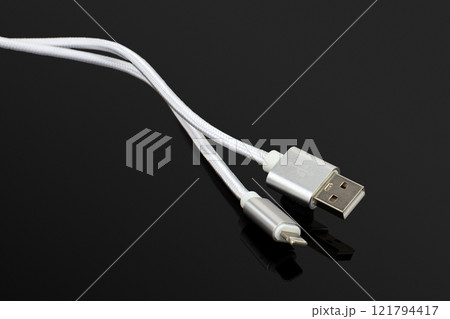 Silver USB Charging Cable on Black Background 121794417