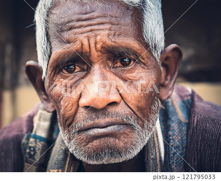 Old grumpy wrinkled man looking at camera 121795033