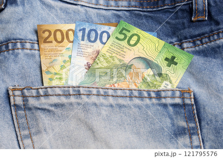 Swiss franc in the pocket of blue jeans 121795576