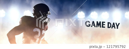 American Football player in helmet standing on field with stadium lights, game day text 121795792