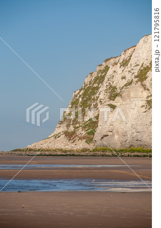 Stunning Serene Coastal Cliffs Stand Majestically Against a Brilliantly Clear Blue Sky Stunning Serene Coastal Cliffs Stand Majestically Against a Brilliantly Clear Blue Sky 121795816