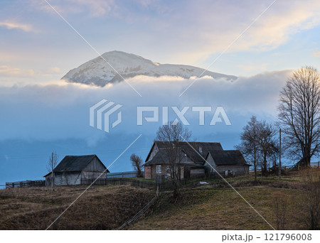 Picturesque morning above late autumn mountain countryside. Ukraine, Carpathian Mountains, Petros top in far. Peaceful traveling, seasonal, nature and countryside beauty concept scene. Picturesque morning above late autumn mountain countryside. Ukraine, Carpathian Mountains, Petros top in far. Peaceful traveling, seasonal, nature and countryside beauty concept scene. 121796008