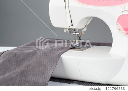 Sewing machine, stitching fabrics, needle in a round plan 121796288