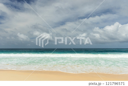 Shore waves and white sand are under dramatic dark cloudy sky Shore waves and white sand are under dramatic dark cloudy sky 121796571