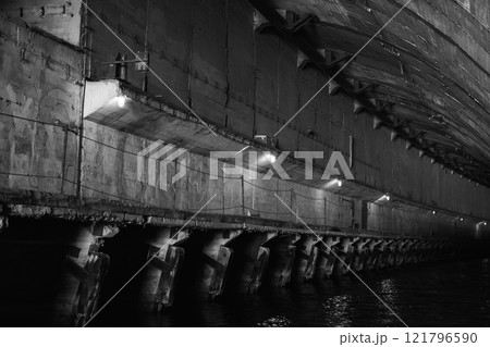 Empty concrete tunnel interior 121796590