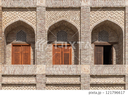 Madrasah wall with decorated arched balconies. Bukhara, Uzbekistan Madrasah wall with decorated arched balconies. Bukhara, Uzbekistan 121796617