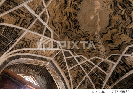 An ancient dome made of bricks with white decorative Arabic pattern 121796624