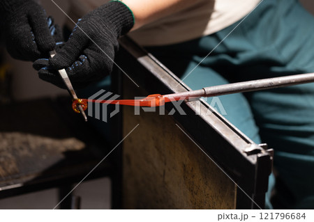 Molten glass sculpting, works of a glass blowing workshop Molten glass sculpting, works of a glass blowing workshop 121796684