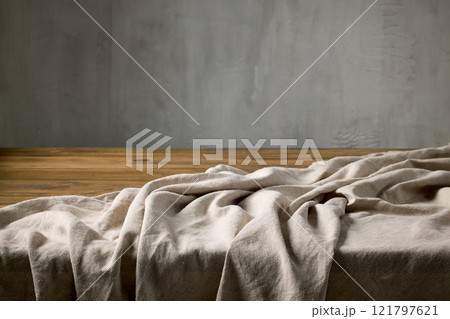 empty rustic wooden table and linen tablecloth 121797621