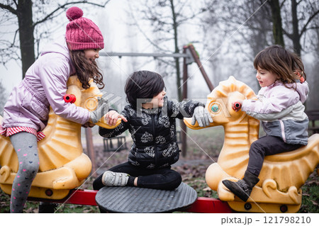 little girls playing at children's playground having fun little girls playing at children's playground having fun 121798210