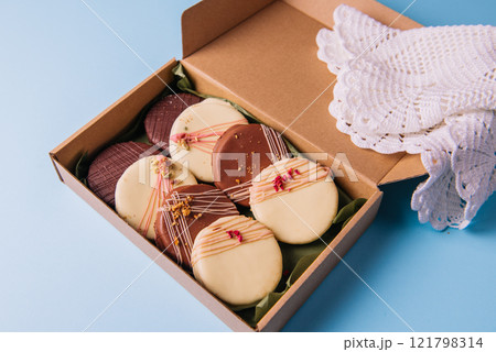 Ischler cookies coated with brown and white chocolate glaze in the box Ischler cookies coated with brown and white chocolate glaze in the box 121798314