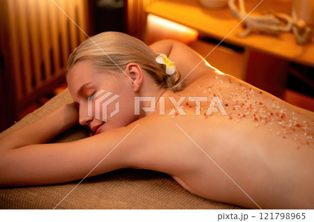Woman customer having exfoliation treatment in luxury spa. Quiescent Woman customer having exfoliation treatment in luxury spa. Quiescent 121798965
